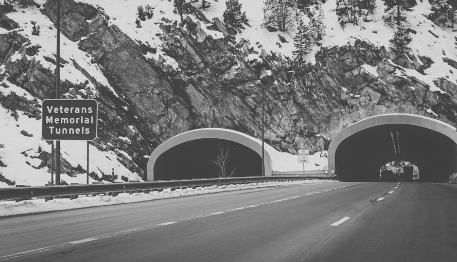 Black and white image of the Veterans Memorial Tunnels with snow-covered mountains.