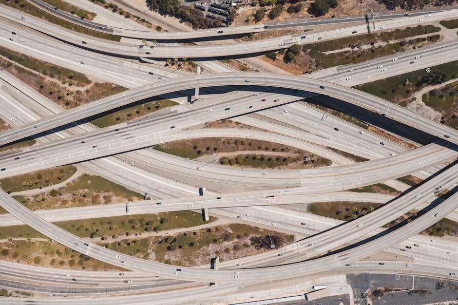 Aerial shot of sprawling highway interchange in Los Angeles with sparse traffic.